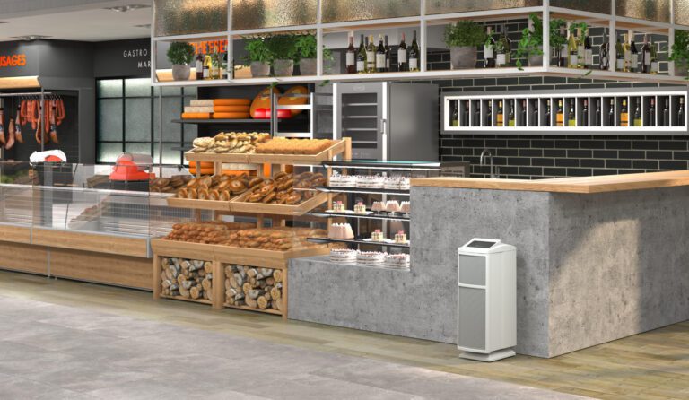 The Intellipure Ultrafine 468 air purifier is displayed in a food market that offers baked goods, meats, and more.