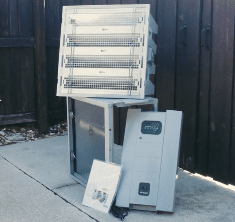 The Intellipure Ultrafine Whole House Air Cleaner, which is known as the Super V, is disassembled and on display outside in front of a fence.